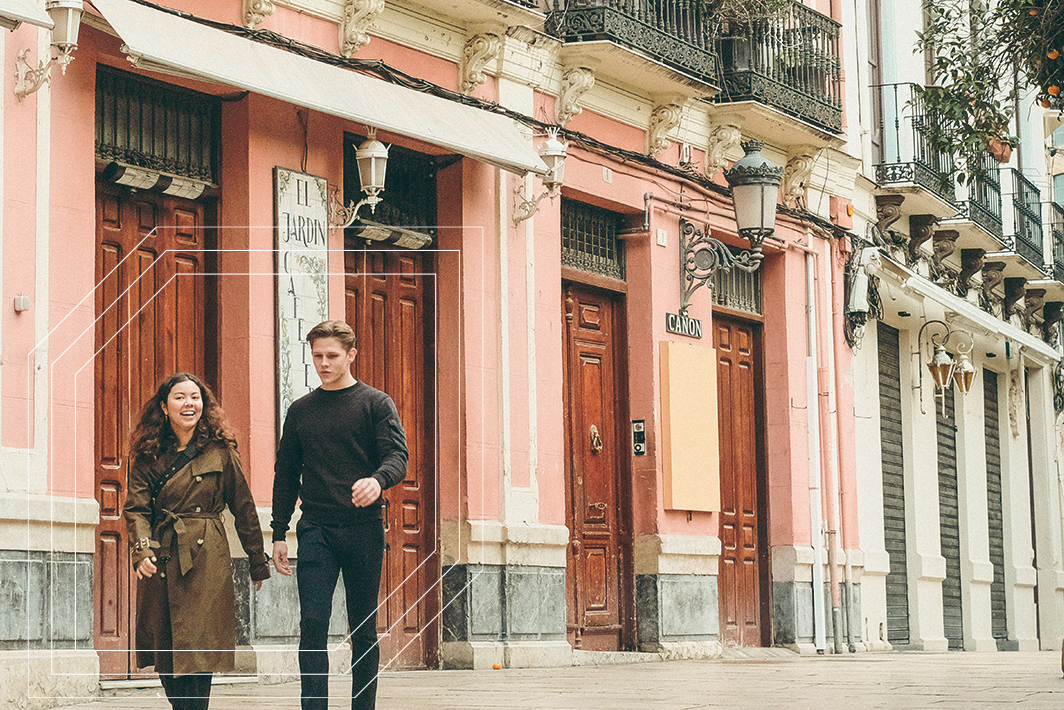 Two people walking down the street