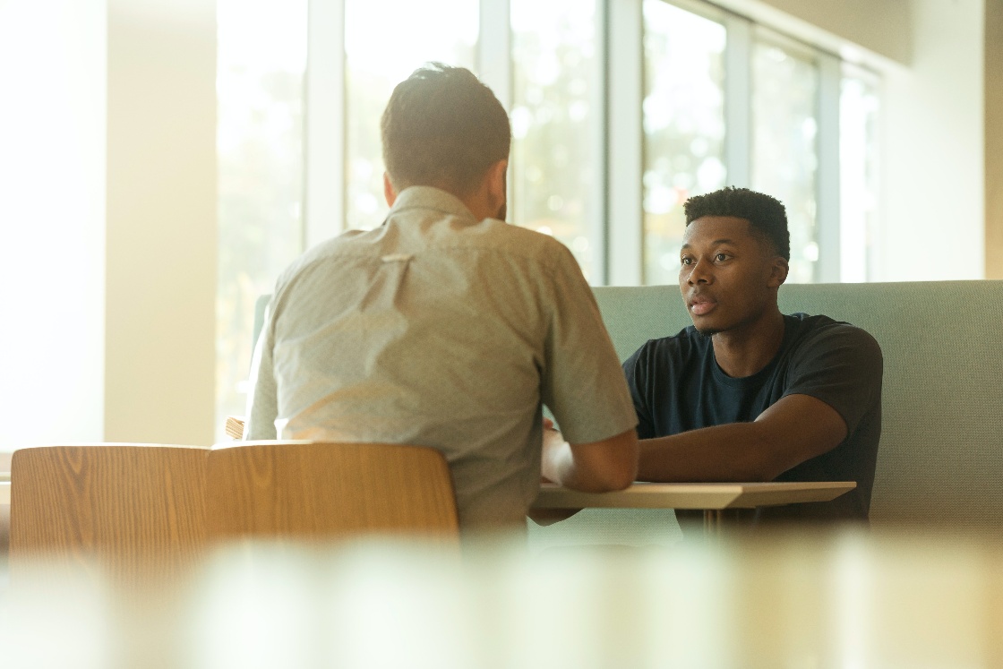 Twee mannen in gesprek aan tafel