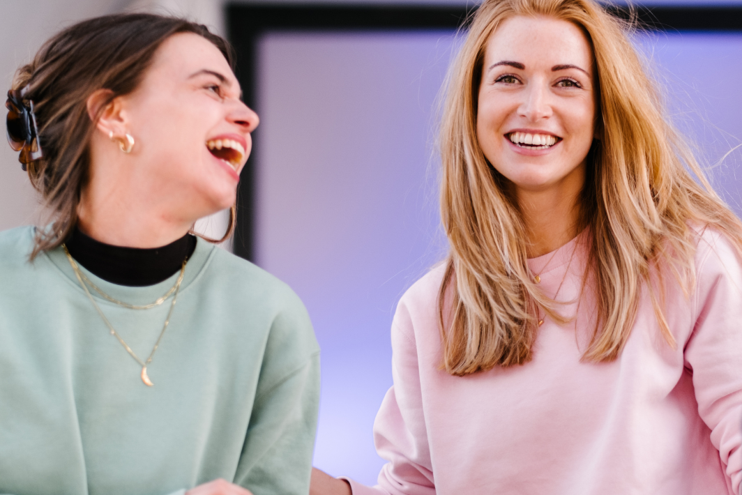 Two woman laughing 
            